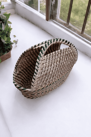 Handcrafted Sabai grass utility basket with woven handle design