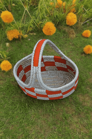 Handwoven Sabai storage basket with terracotta and ivory checkered pattern