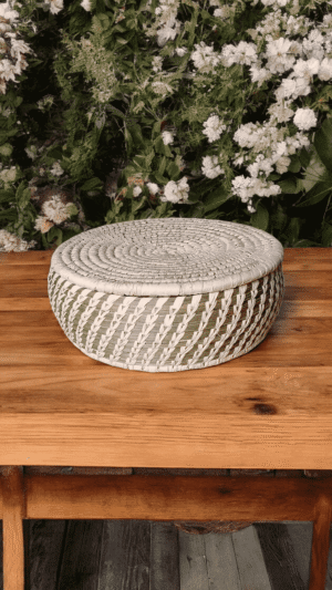 Handwoven ivory Sabai grass storage basket with matching lid and spiral weave design
