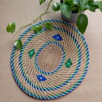 Handwoven Sabai grass door mat with blue and green spiral woven pattern