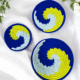 Sabai grass wall decor plate set with blue yellow and white spiral woven design