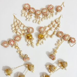 Handcrafted floral cowrie shell jewelry set with necklace earrings and maang tikka for haldi and mehendi