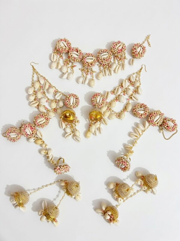Handcrafted floral cowrie shell jewelry set with necklace earrings and maang tikka for haldi and mehendi