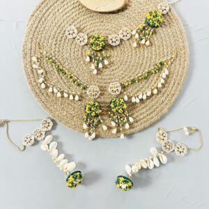 handcrafted floral cowrie shell jewelry set with green stones necklace earrings for haldi mehendi bridal look