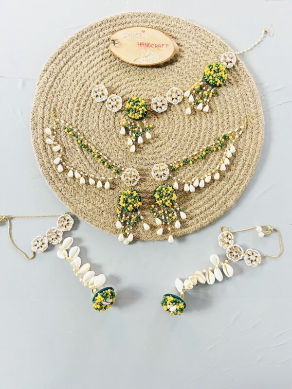 handcrafted floral cowrie shell jewelry set with green stones necklace earrings for haldi mehendi bridal look