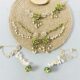 handcrafted floral cowrie shell jewelry set with green stones necklace earrings for haldi mehendi bridal look