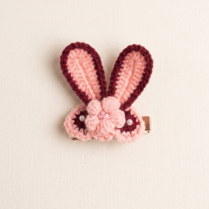 Handmade blush pink crochet bunny hair clip with floral details and pearl accents