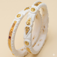 White Sankha bangles with gold decorative accents and traditional design
