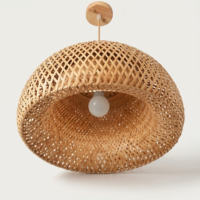 Handwoven twisted halo cane pendant lamp with artistic circular design and natural woven texture