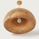Handwoven twisted halo cane pendant lamp with artistic circular design and natural woven texture